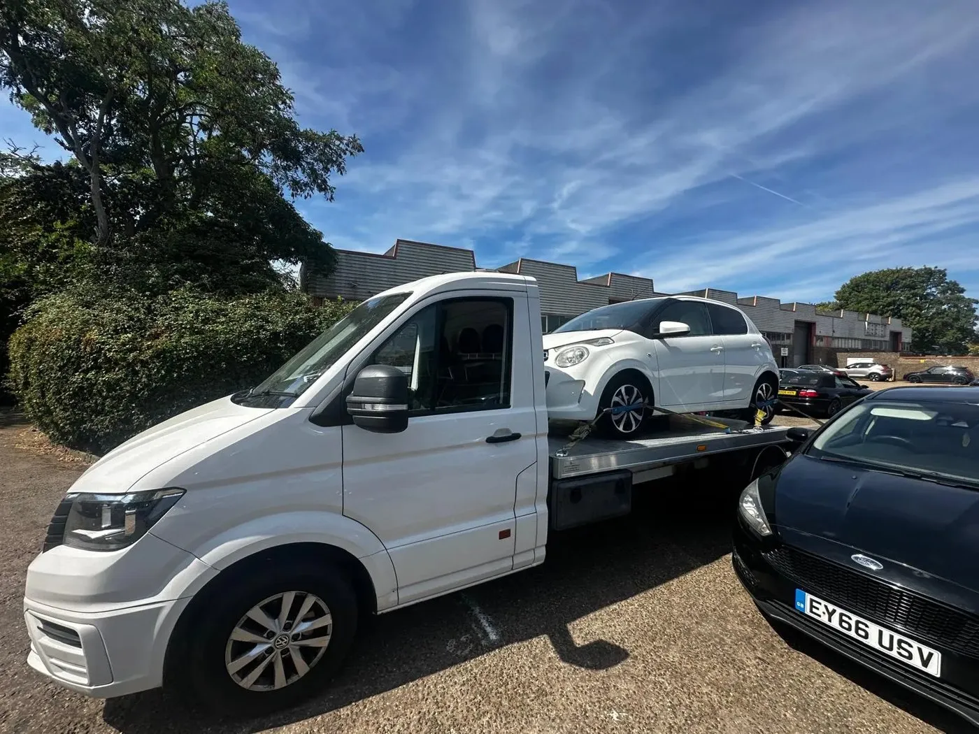 Car recovery truck collecting a broken down vehicle on a Peterborough residential street